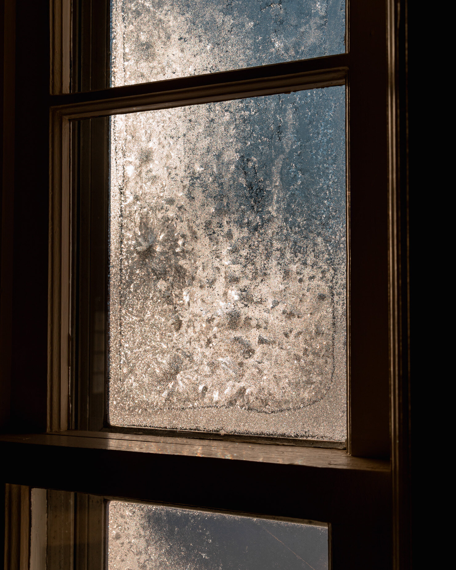 A head-on shot shows a frosted window illuminated by morning sun.