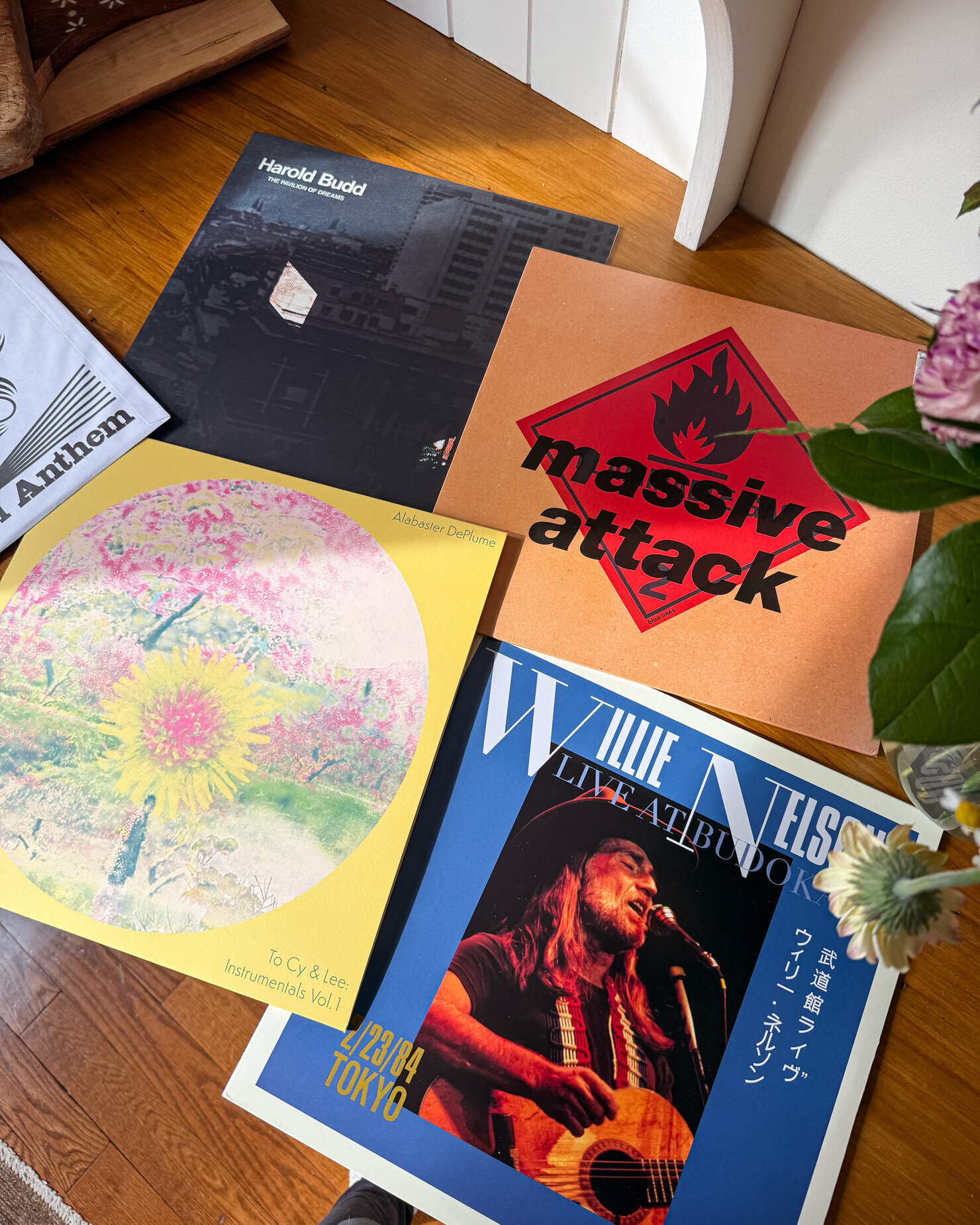 An overhead shot shows 4 records on a wood countertop: Harold Budd, Massive Attack, Alabaster DePlume, and Willie Nelson.